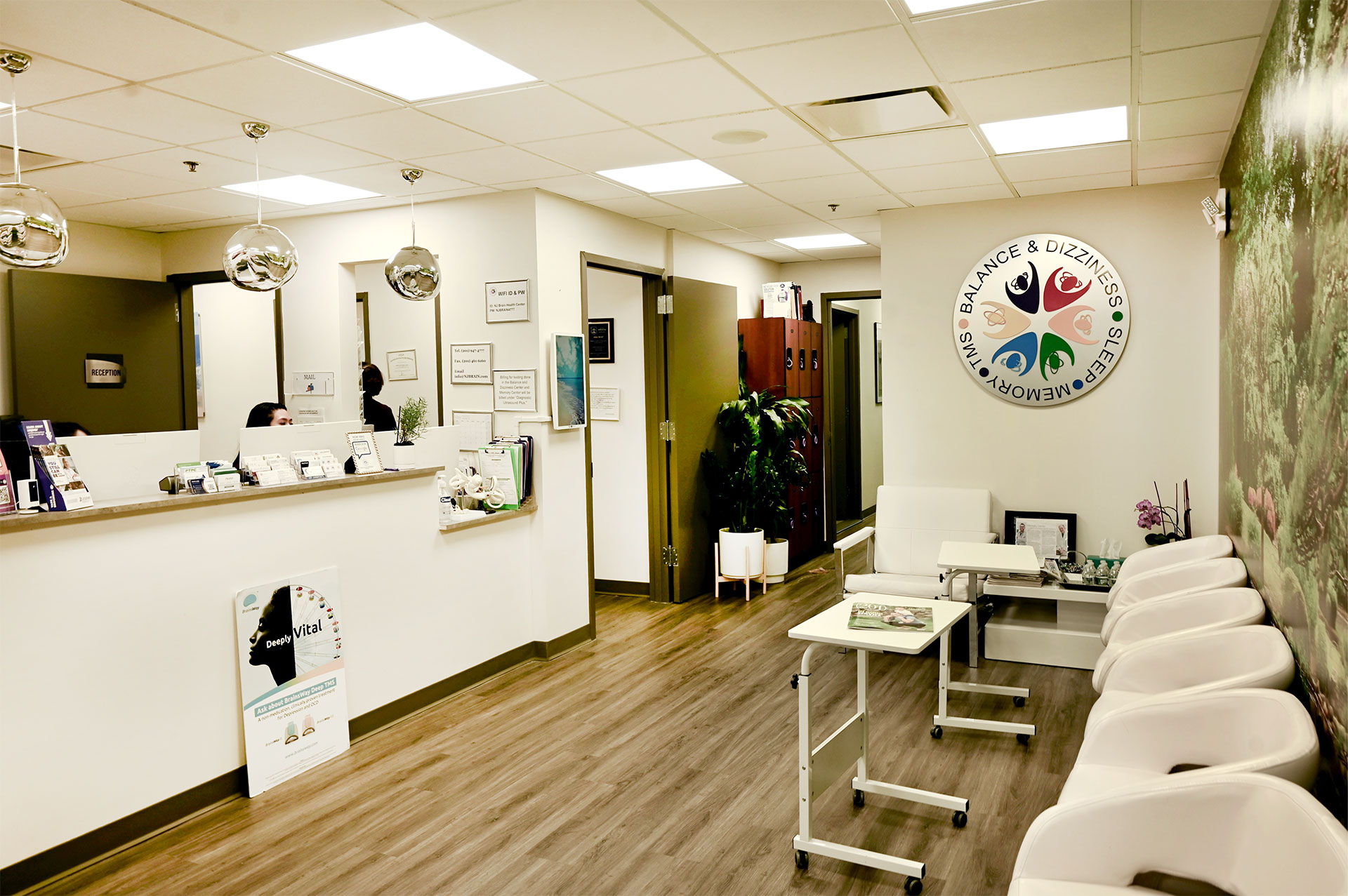The image depicts an interior space that appears to be a dental office waiting area, with a clean and organized appearance, featuring a reception desk, chairs, and a sign.